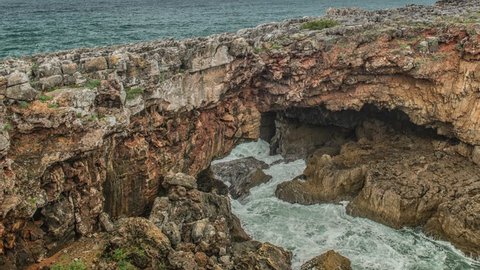 Dangerous ocean waves crash into cliff, Devil Mouth (Boca do Inferno), Portugal