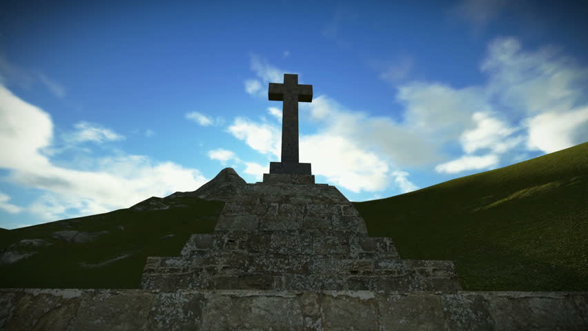 Crucifix on the mountain with sunrays