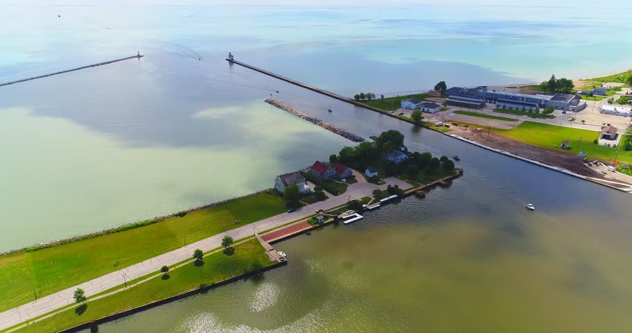 Splendid aerial view of sunlight and moving cloud shadows on Lake Michigan’s beautiful Kewaunee Wisconsin Harbor.