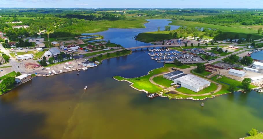 Splendid aerial view of sunlight and moving cloud shadows on beautiful Kewaunee Wisconsin Harbor.
