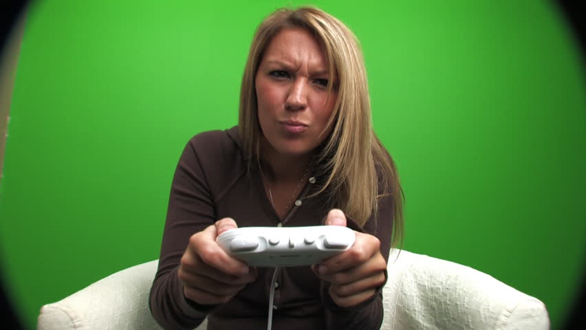 A college-aged girl plays a video game. Don't want to go through the chroma key