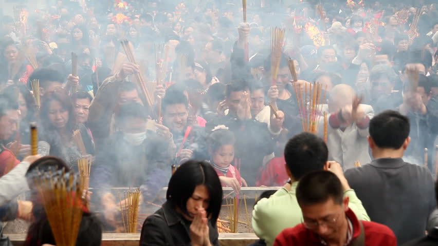 GUANGZHOU - FEBRUARY 3: People burn incense in temple during Chinese New Year on