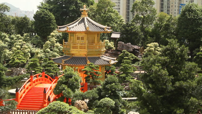 Red Wooden Arch Bridge and Golden Pavilion in Nan Lian Garden, Hong Kong.