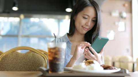 Woman use of cellphone in restaurant 