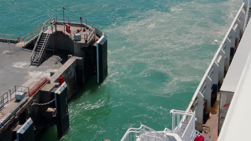 A large ocean ferry leaving the harbor to cross the ocean with all of its cars and people