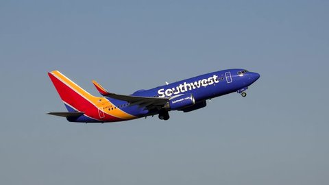 Southwest Airlines Boeing 737 climbs into blue sky as it takes off from the runway - Logan Airport Boston, Massachusetts USA - July 2, 2017