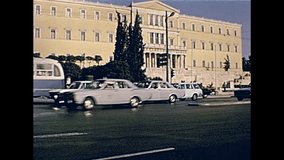 The Greek Hellenic parliament of Athens by the Leoforos Vasilissis Sofias street with vintage cars traffic in Greece. Restored historical 70s archival footage on circa 1972.