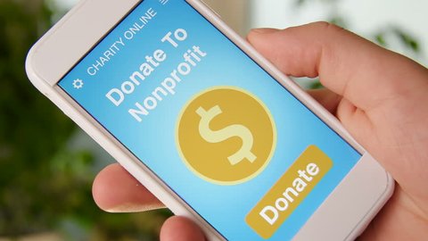 Man making an online donation to nonprofit organization using charity applicaiton on smartphone