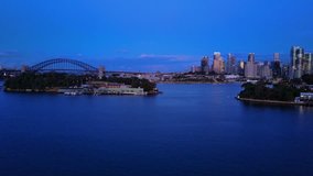 Aerial video of Sydney Harbour at night, with view of Harbour Bridge, Opera House and skyline of CBD