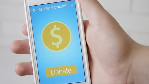 Man making an online donation using charity applicaiton on smartphone