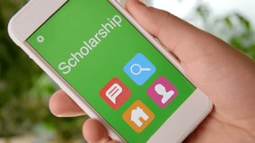 Scholarship concept application on the smartphone. Man uses mobile app. - Powered by Shutterstock - Get 15% off with code: PIKWIZARD15