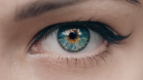 Young Woman is opening and closing her beautiful eye. Macro Close-up eye blinking.