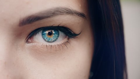 Beautiful female blue eyes. Young Woman is opening and closing her beautiful eye.