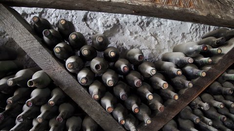 Old Bottles of wine in traditional wine cellar