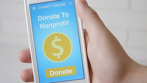 Man making an online donation to nonprofit organization using charity applicaiton on smartphone