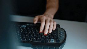 Man play video game using keyboard with red buttons