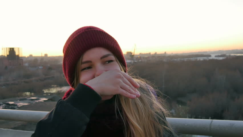 Girl laughs and grabs her hair close up