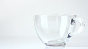 Video clip. A cup of Chinese green tea on a white background.