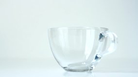 Video clip. A cup of Chinese green tea on a white background.