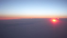 View of clouds from the airplane window. The sun in the clouds. Sunrise. Realtime video