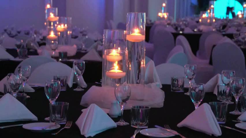 A themed evening dinner table set up for a Conference or wedding venue, candles