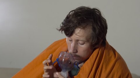 Closeup shot of a young man that cures sickness using an ultrasonic inhalation.