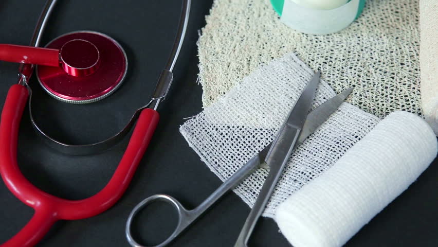 Medical bandages with scissors, sticking plaster and medical stethoscope on black background. Medical instruments.
 Royalty-Free Stock Footage #28608064