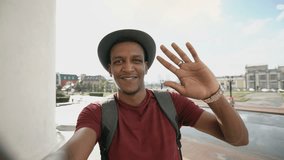 African american tourist man having online video chat using his smartphone camera while travelling in Europe