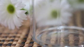 Pouring brown rice into glass jar closeup macro blur background