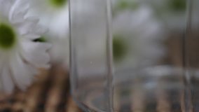 Pouring rice into glass jar closeup macro blur background