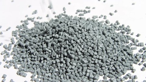 Plastic pellets . The dye granules for polypropylene polystyrene falling on a light background