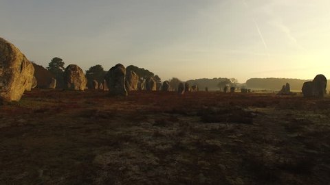 Flying over the famous "Alignements de Carnac" located in Carnac, Morbihan, Brittany, France. Sunrise on the Megaliths of Kermario, one of the largest Megalithic complex in the world.