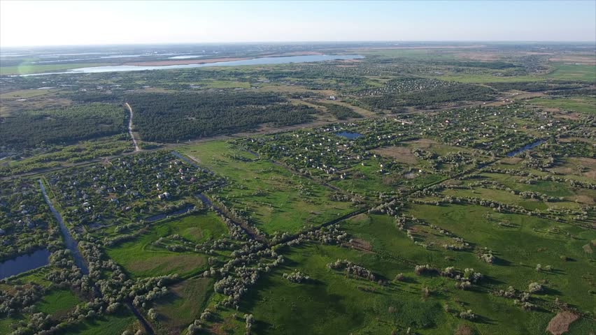 Unusual view on small lakes, a road, and reedbeds with a lot of cane, sedge, and rush from a bird`s eye perspective in Ukraine in a sunny day in summer. The landscape is very unusual for Europe