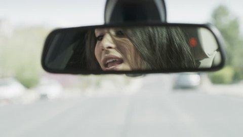 Close up of woman singing in car mirror / Cedar Hills, Utah, United States