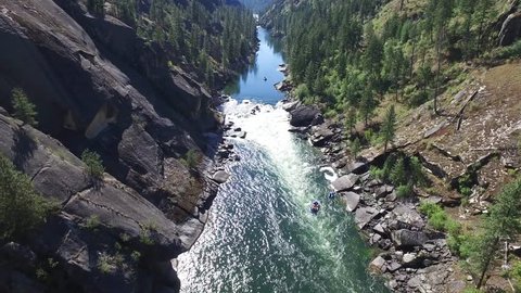 A wonderful aerial footage of Salmon River in Idaho, flanked by huge rocks and pine trees. The sun makes a striking reflection on the water too. Shot in real time.