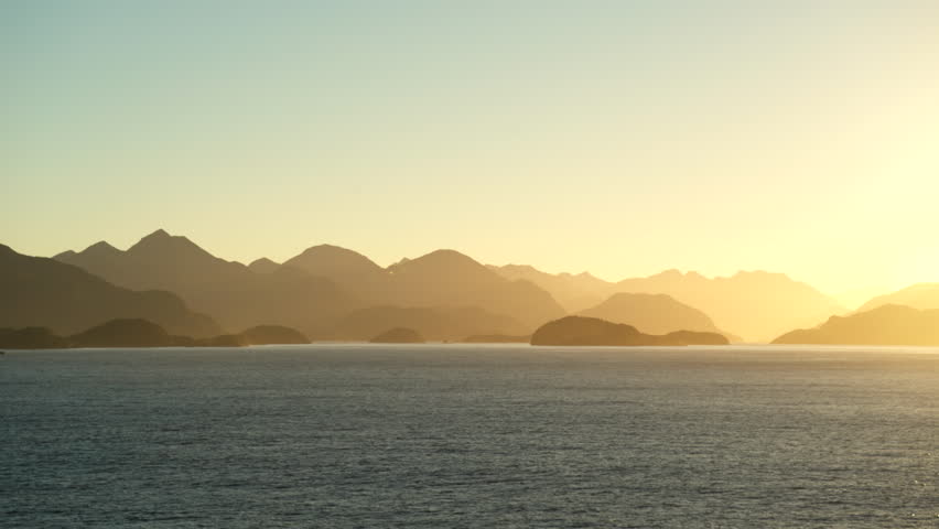 Stunning sunset at sea. New Zealand coastline, relief silhouette