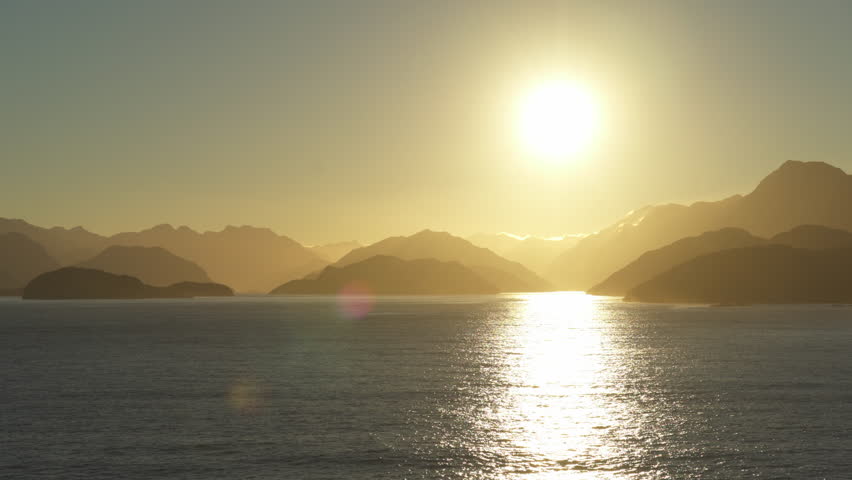 Stunning sunset at sea. New Zealand coastline, relief silhouette