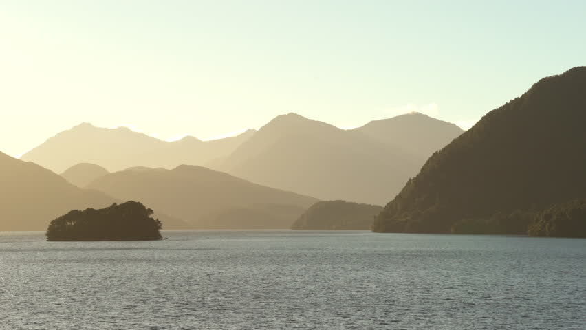 Stunning sunset at sea. New Zealand coastline, relief silhouette