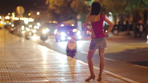 a whore waiting for a customer on street  in the evening