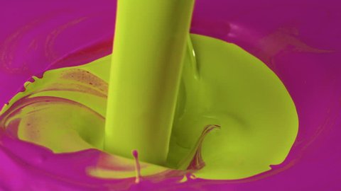 Pouring yellow paint into pink paint shooting with high speed camera, phantom flex.
