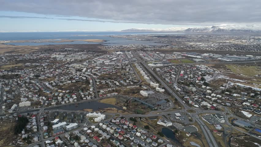 Aerial shot of the town of Hafnarfjordur close to Reykjavik city Iceland, looking out over the harbor and ocean shot in 4k on a phantom 4 pro