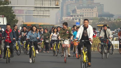 Crowd of cyclist in Beijing. Chaotic, crowded street scene - March 2017: Beijing Tiananmen, China
