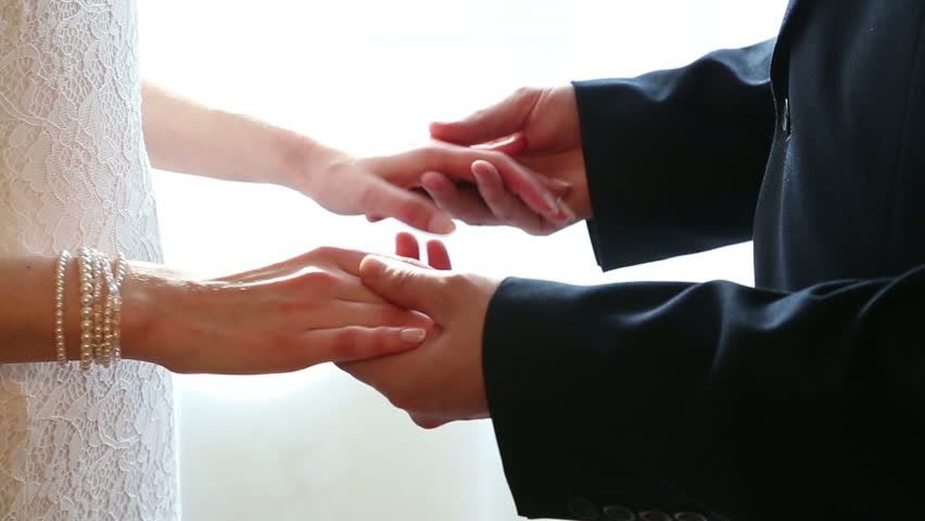The hands of the newlyweds meet on a light background | Shutterstock HD Video #28650850