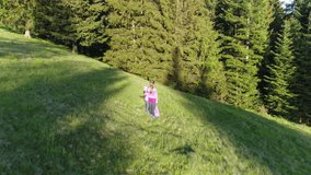 Aerial shot, family walking along, spring day in forest