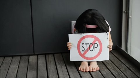 Young girl show child abuse sign.