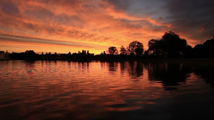 Red sunset over City Park Lake in Denver Colorado. HD 1080p.
