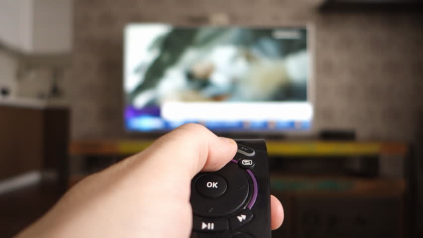 Male hand holding the TV remote control and turn off smart tv. Channel surfing, focused on the hand and remote control. Internet TV. Programm on demand. Royalty-Free Stock Footage #28657414