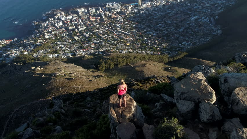 Aerial view of young woman reaching mountain top
Aerial view of a young woman reaching the top of Lion's head mountain in Cape Town, South Africa. Royalty-Free Stock Footage #28660504