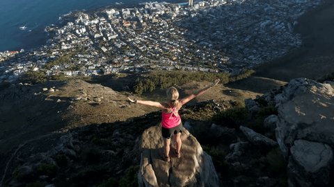Aerial view of young woman reaching mountain top
Aerial view of a young woman reaching the top of Lion's head mountain in Cape Town, South Africa.
