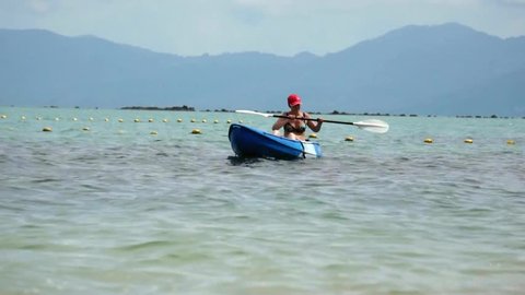 Woman kayaking at tropical sea